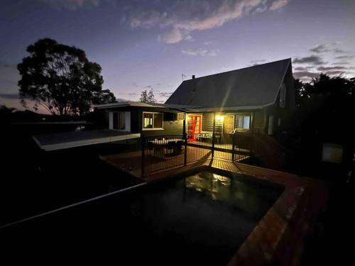 a house with a swimming pool in front of it at Gorgeous 3 bedroom raked ceiling cabin on the hill in Blackbutt