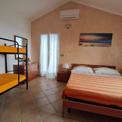 a bedroom with a bed and a bunk bed at Uliveto in Diano San Pietro