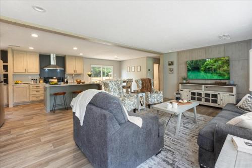 a living room with a couch and a kitchen at Ichetucknee Springs 2 MI - Fire Pit Pavilion & Grill in Fort White