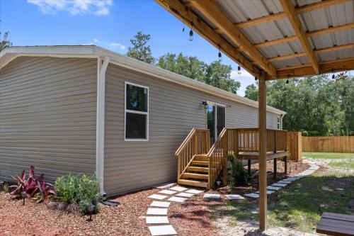 a house with a porch and a deck at Ichetucknee Springs 2 MI - Fire Pit Pavilion & Grill in Fort White