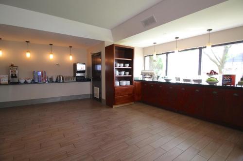 a large room with a kitchen and aasteryasteryasteryasteryasteryasteryasteryastery at Country Inn & Suites by Radisson, Sandusky South, OH in Milan