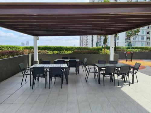 a group of tables and chairs under a canopy at Larkin bus terminal Doraemon Home by YHA in Johor Bahru