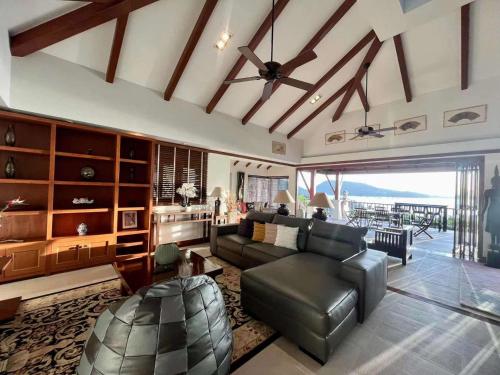 a living room with a couch and a table at Patong Seaview Luxury Villa Penda in Patong Beach