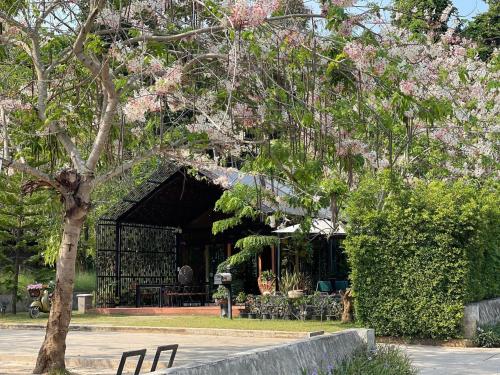 a pavilion with tables and chairs in a park at Rock Forest in Sattahip