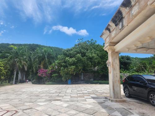 a car parked in a parking lot with trees at Villa Tesoros del Mar - Luxury Beachfront Villa with Natural Pool, Jacuzzi, Mountain Views, Yoga, BBQ, Wi-Fi, Pet & Family Friendly, Barahona Adventures in El Arroyo