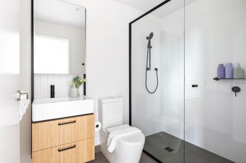 a bathroom with a toilet and a shower at Urban Rest Southbank in Melbourne