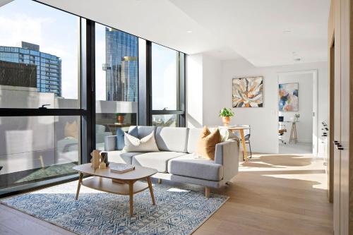 a living room with a couch and a table at Urban Rest Southbank in Melbourne