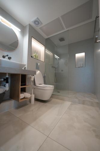 a bathroom with a toilet and a sink and a shower at Panoramic Sea View Luxury Suite in Netanya