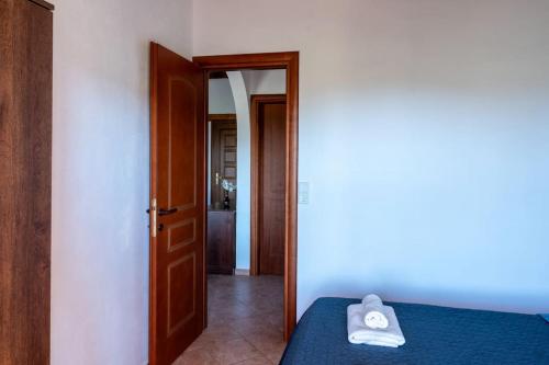 a bedroom with a bed with a pair of towels on it at House Demetra in Astris