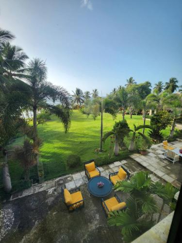 an aerial view of a patio with chairs and a table at Villa Tesoros del Mar - Luxury Beachfront Villa with Natural Pool, Jacuzzi, Mountain Views, Yoga, BBQ, Wi-Fi, Pet & Family Friendly, Barahona Adventures in El Arroyo