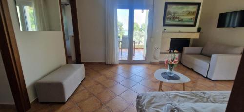 a living room with a couch and a table at Makis Nest Apart-Hotel in Vourvourou