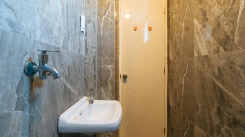 a bathroom with a sink on a wall at RedDoorz @ Recson Boracay Hostel in Boracay