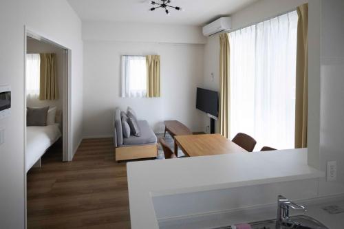 a living room with a couch and a table at Shino Garden Residence in Tokyo