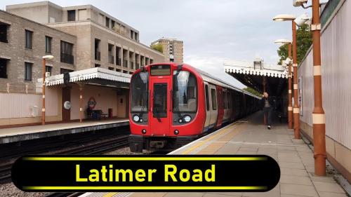 a red train is pulling into a train station at LGBTQ-Double room in London