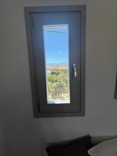 a window in a room with a view at CAELI PAROS by Kostas & Joanna Studios in Logaras