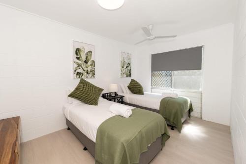 a bedroom with two beds and a window at 2-Bedroom Charm near Mater Hospital Pimlico in Aitkenvale