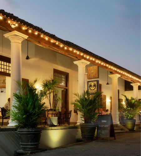 a restaurant with plants in front of a building at Galle Fort Hotel in Galle