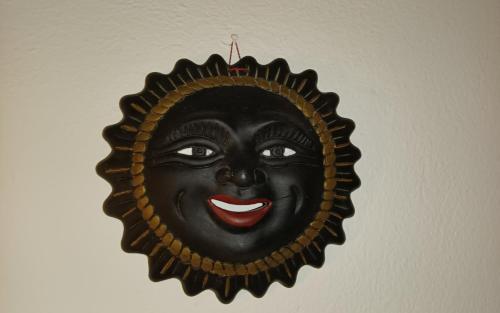 a picture of a black mask hanging on a wall at Casa Vacanze Eloise in Quartu SantʼElena