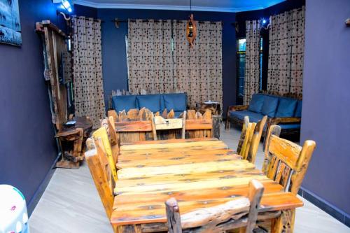 a dining room with a wooden table and chairs at Love House in Dodoma