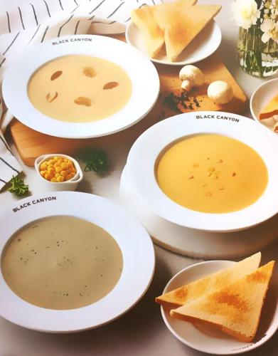 een tafel vol witte borden met soep en brood bij Sea Star House in Ao Nang Beach