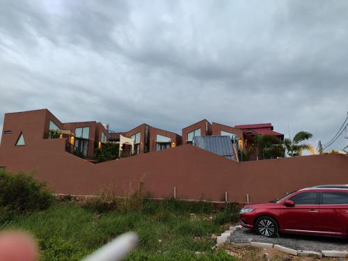 a red car parked in front of a building at Vanilla Ho Tram Homestay in Ho Tram