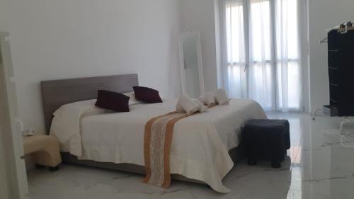 a bedroom with a bed with white sheets and pillows at Margherita's House in Turin
