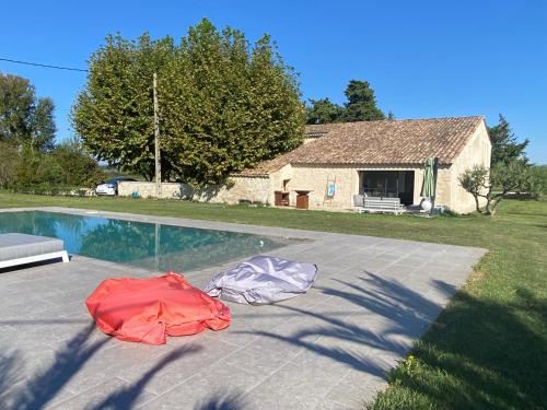 two tents laying on the ground next to a swimming pool at La Ferme, propriété d'exception in Puygiron