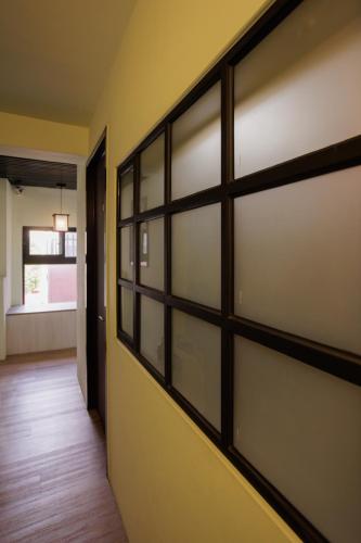 a sliding barn door with glass panels in a hallway at 赤樓古巷民宿 6-12人可包棟 in Tainan