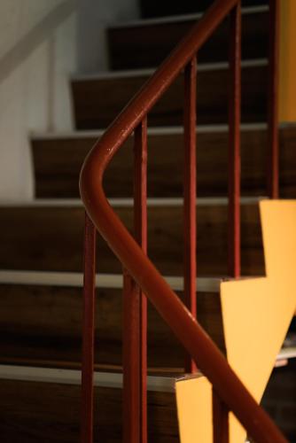 a close up of a staircase with brown rails at 赤樓古巷民宿 6-12人可包棟 in Tainan