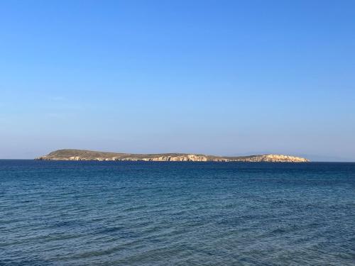 an island in the middle of a large body of water at CAELI PAROS by Kostas & Joanna Studios in Logaras