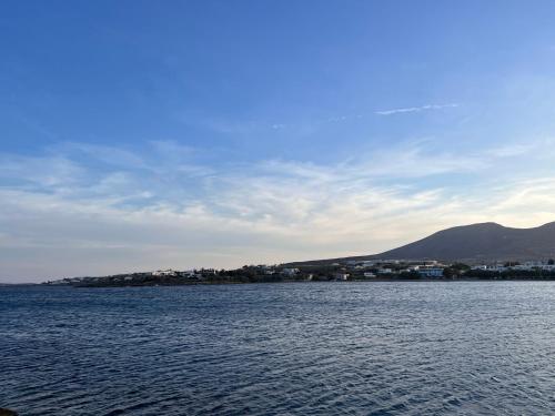 a large body of water with mountains in the background at CAELI PAROS by Kostas & Joanna Studios in Logaras