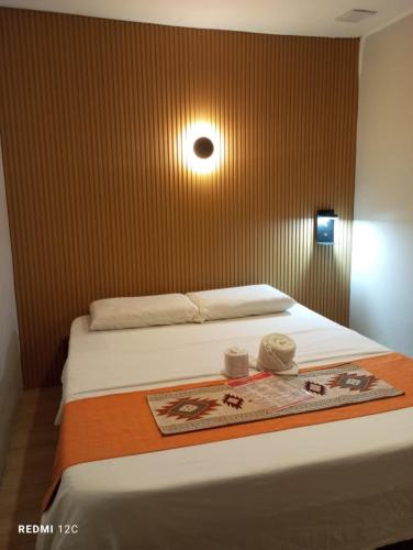 a bedroom with a bed with a blanket and two candles at Airport Hostel Manila in Manila