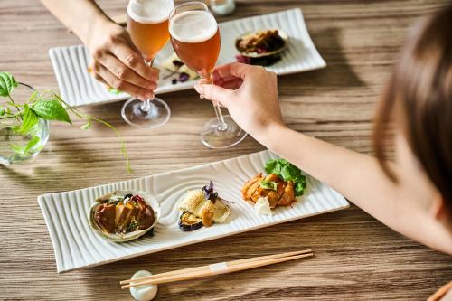 a group of people sitting at a table with plates of food at Laforet Hakone Gora Yunosumika in Hakone