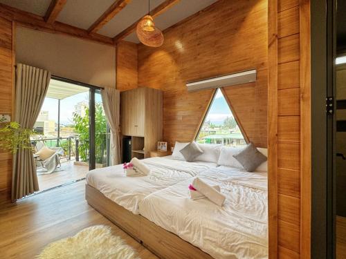 a bedroom with a large bed with a large window at Vanilla Ho Tram Homestay in Ho Tram