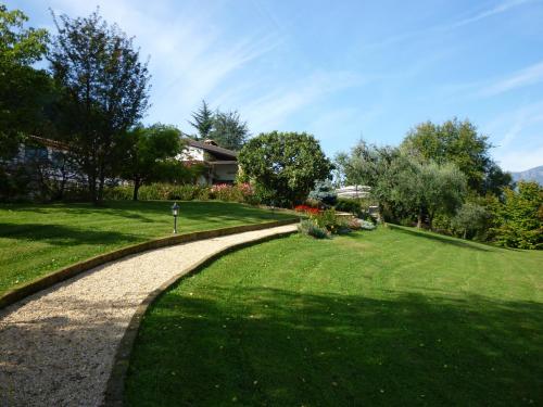 a winding path in a park with a house at Country House Barone D'Asolo in Asolo