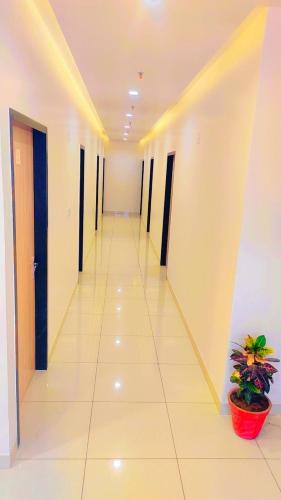 a hallway of an office building with a plant at Hotel Rajvi Residency A Unit Of Jas Hotels And Resorts in Bikaner