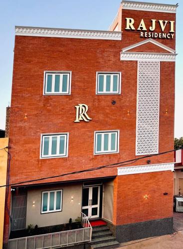 a red brick building with a rtkissonisson sign on it at Hotel Rajvi Residency A Unit Of Jas Hotels And Resorts in Bikaner