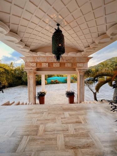 a pavilion with a chandelier hanging from the ceiling at Villa Tesoros del Mar - Luxury Beachfront Villa with Natural Pool, Jacuzzi, Mountain Views, Yoga, BBQ, Wi-Fi, Pet & Family Friendly, Barahona Adventures in El Arroyo