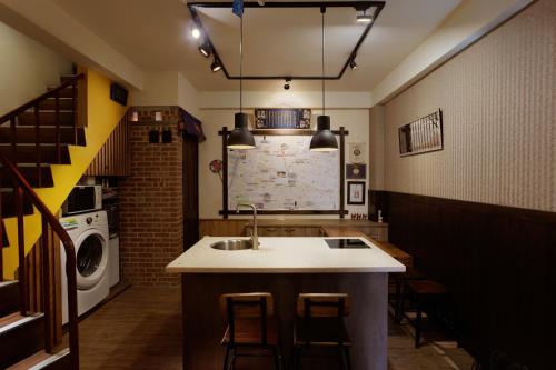 a kitchen with a sink and a washing machine at 赤樓古巷民宿 6-12人可包棟 in Tainan