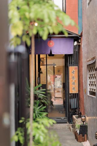 an entrance to a building with a purple awning at 赤樓古巷民宿 6-12人可包棟 in Tainan