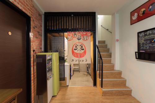 a hallway with stairs and a sign on the wall at 赤樓古巷民宿 6-12人可包棟 in Tainan