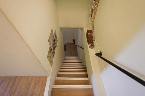 a staircase in a house with wooden floors at 赤樓古巷民宿 6-12人可包棟 in Tainan
