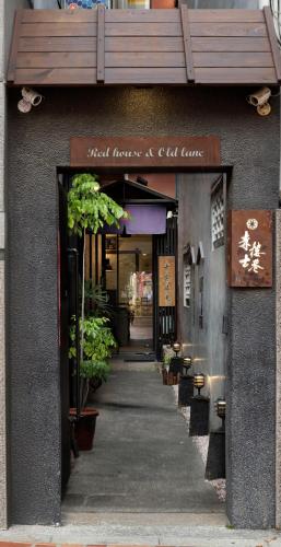 a building with a sign that reads first flowers and cell care at 赤樓古巷民宿 6-12人可包棟 in Tainan