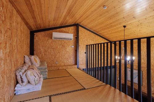a small room with a wooden ceiling and a heater at 赤樓古巷民宿 6-12人可包棟 in Tainan