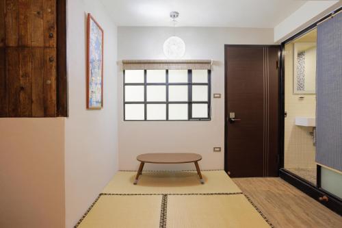 a small table sitting on a rug in a hallway at 赤樓古巷民宿 6-12人可包棟 in Tainan