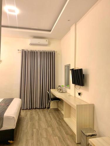 Ένα ή περισσότερα κρεβάτια σε δωμάτιο στο Kurnia perdana Hotel