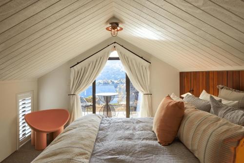 a bedroom with a bed and a large window at Newton Heights in Akaroa