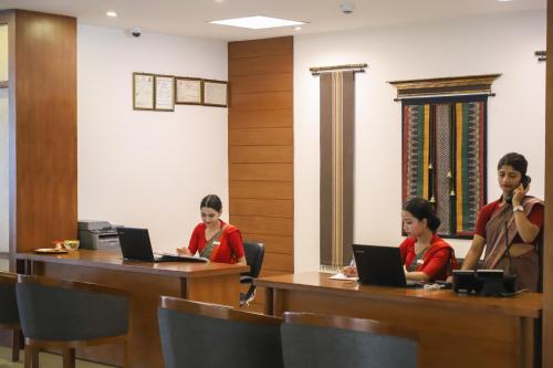 a group of women sitting at tables with laptops at Mountain Glory Forest Resort in Pokhara