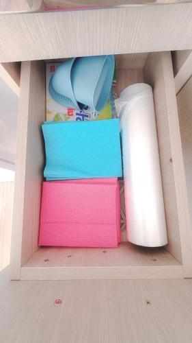 a pile of colored towels underneath a table at Garden in Jeju 201 in Seogwipo