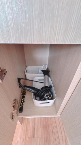 a corner of a cupboard with a kitchen appliance at Garden in Jeju 201 in Seogwipo